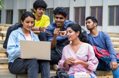 istockphoto-1461630610-612x612 Group of happy students checking results on laptop while sitting on college campus - concept of education, technology and project work discussion